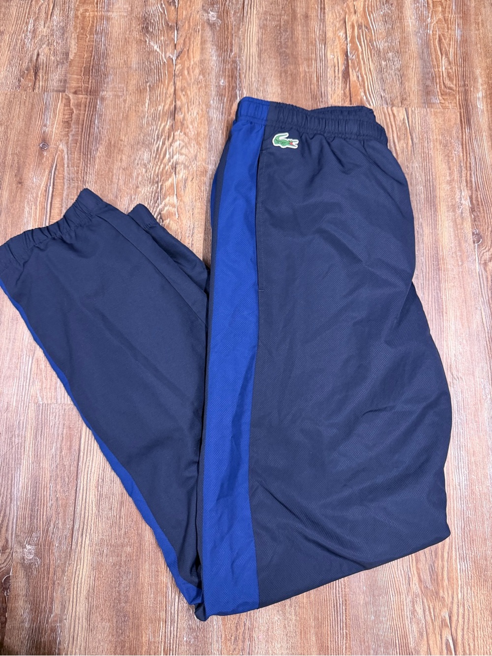 Lacoste Sport navy blue track pants with blue side stripe, size M